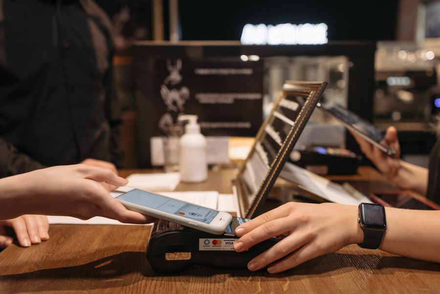 Contactless payment with a phone at a café counter